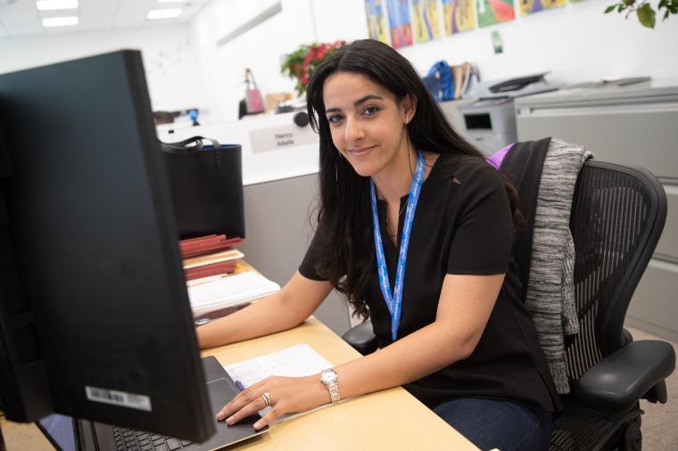 Santa Clara student sits at a computer in an office setting 