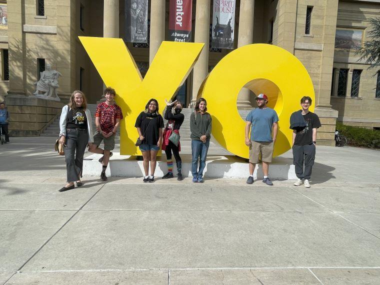 group of students in front of YO letters