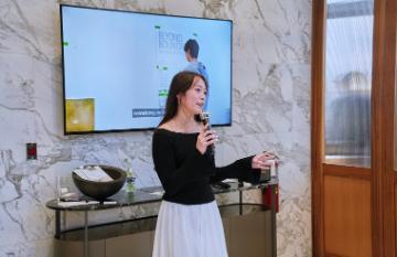 Girl with a mic speaking at an event