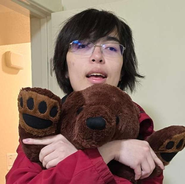 Cyrus Wong hugging a stuffed bear