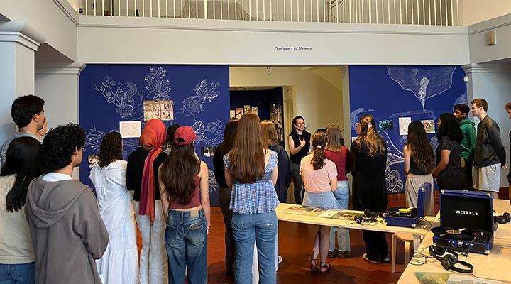 Students in the De Saisset Museum lobby listenng to a presentation
