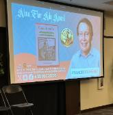 On a presentation screen, Francisco Jiménez and Alma Flor Ada Book Award for Cajas de Cartón