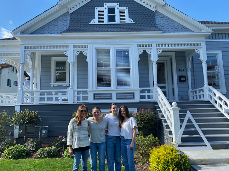 Meghan Brown with daughters Gigi, Addie and Emmy standing in front ofthe SCU Delta Gamma sorority house.