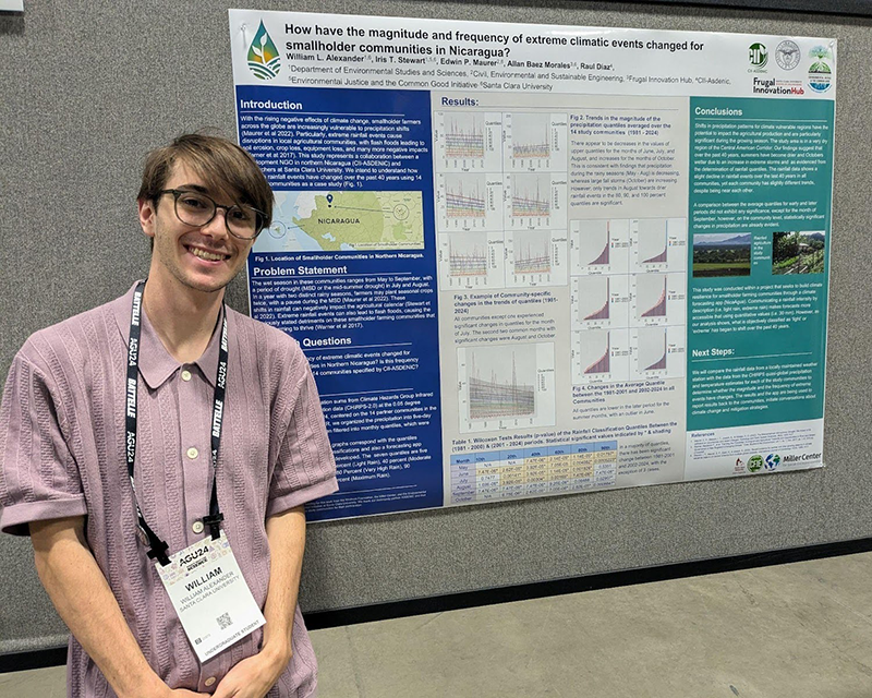 William Alexander standing next to his research poster.