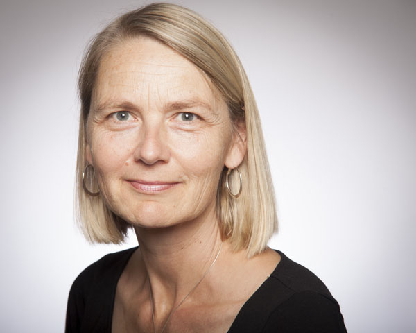Person wearing a black shirt against a plain background.