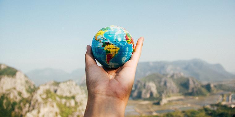 hand holding small globe 