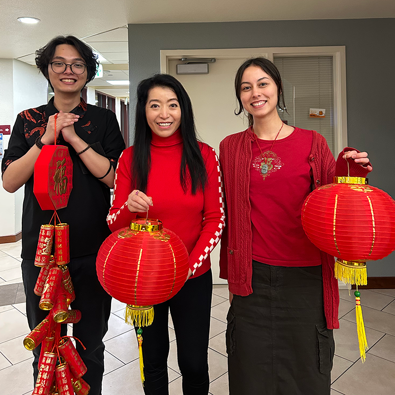 Students and faculty hold their paper lanterns for Chinese New Year.