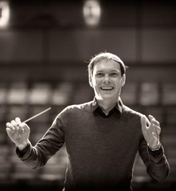 Scot Hanna-Weir joyfully conducting with a baton