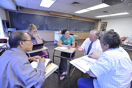 Students and teacher engaged in classroom discussion.