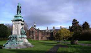 Gladstone Library with a statue and garden in the foreground.