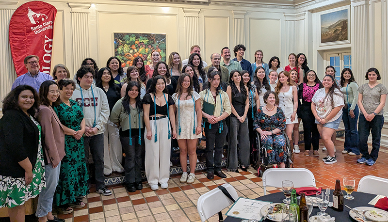 Faculty and Student group photo in the Adobe Lodge