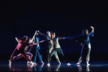 female dancer being torn away from a group