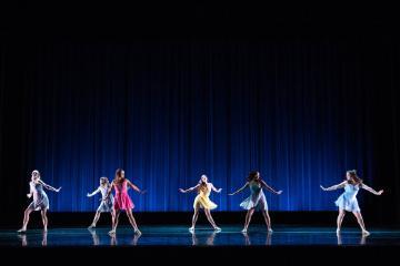 4 female dancers twirling in pastel color costumes 
