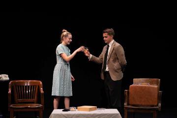 Actor and actress clinking whisky glasses