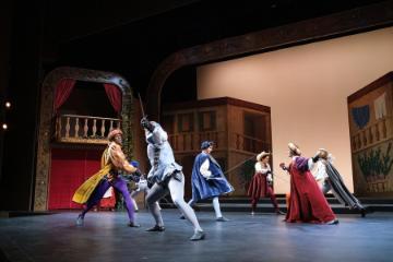 People performing on stage in a scene from 