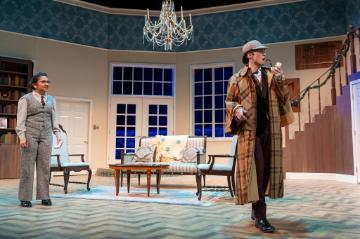 Actors portraying Sherlock Holmes and Dr Watson inside a posh 1930s house