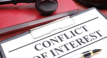 A desktop with book, gavel, clipboard, and pen, and document that has the words, 