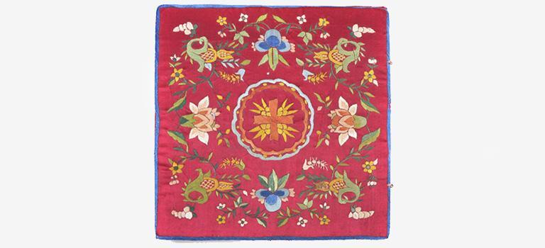 Red burse with colorful floral design.