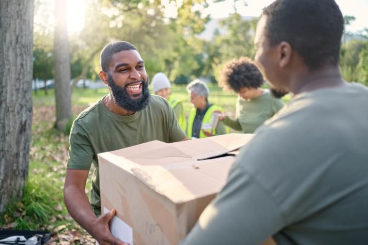 a man handing box to other person