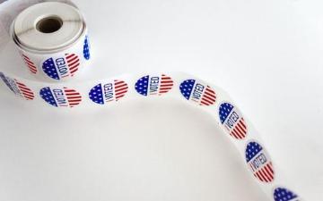 Roll of red white and blue pattern stickers with printed with I Voted slogan 