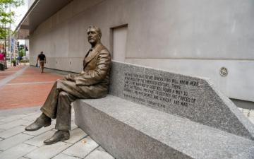 Statue of Franklin Delano Roosevelt sitting on a concrete bench outside the National World War II Museum by Jessica Tan via Unsplash.