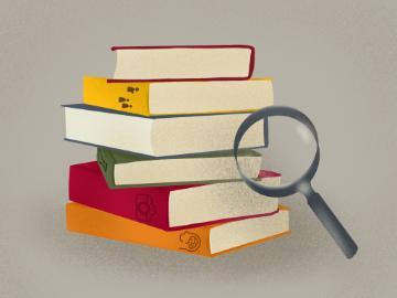 A stack of books with a magnifying glass. 