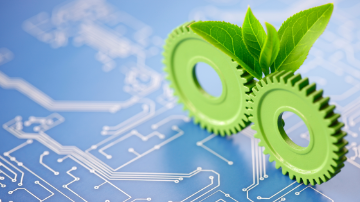 A computer logicboard with green cogs and leaves 
