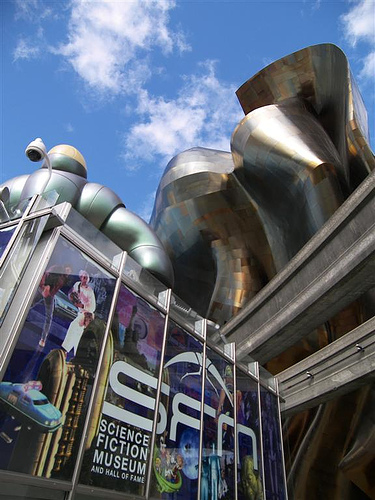 Colorful, modern building entrance with unique architecture under a blue sky.