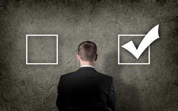 A person stands facing two checkboxes, one empty and one checked.