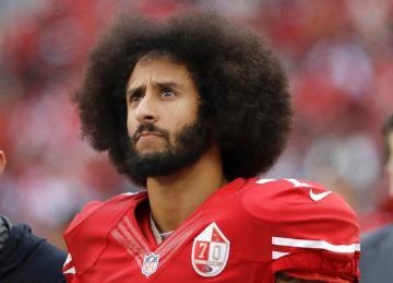 San Francisco 49ers quarterback Colin Kaepernick stands in the bench area during the second half of the team's NFL football game against the New York Jets in Santa Clara, Calif. Kaepernick told CBS he’ll stand during the national anthem if given chance to play football in NFL again. (AP Photo/Marcio Jose Sanchez, File)