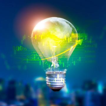 Lightbulb displaying energy saving and financial concepts with cutting-edge technology and creativity By Surasak_Adobe Stock_cropped