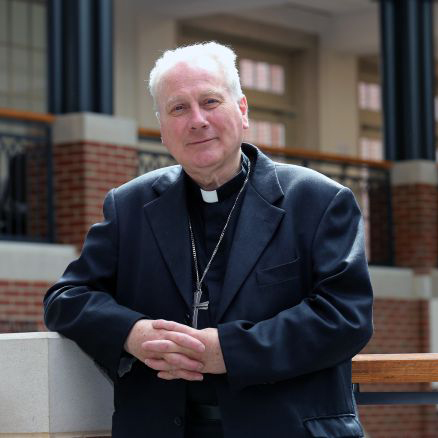 An older man leaning on a railing inside a building. image link to story