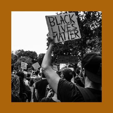 A protester holds a sign reading 