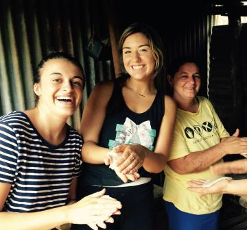 Jenna making tortillas with two other people.