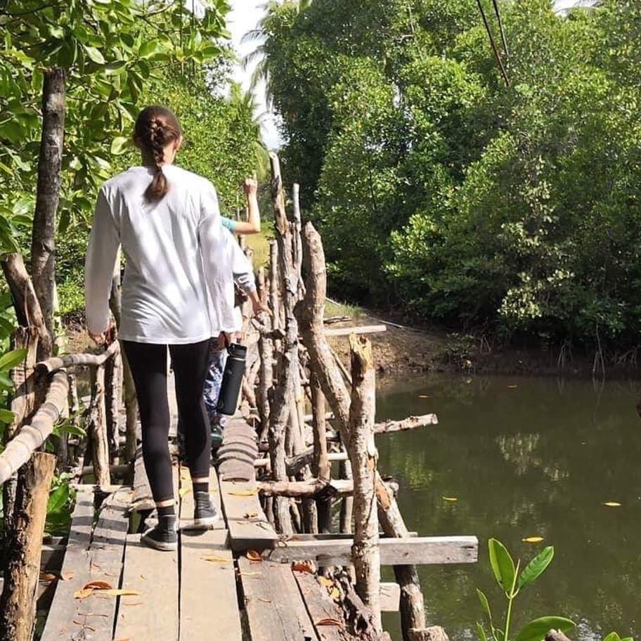 Student walking away on a bridge 
