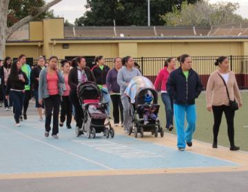A group of people walking outdoors near buildings. image link to story