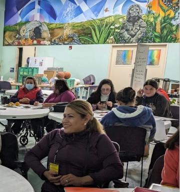 Caminos Al Beinestar Group with Mural in background
