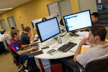 SCU students at PCs in library 