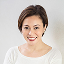 A person smiling in a white shirt.