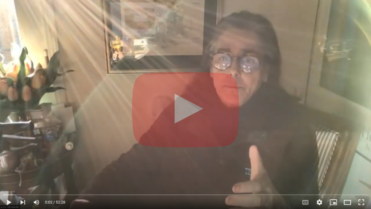 A person giving a thumbs up with a play button overlay.