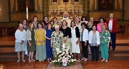 Catala club members standing next to Father Jack