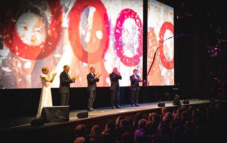 President Sullivan, Larry Sonsini, Jim Lyons, Jeff Miller and John Sobrato on stage announcing $1billion fundraising achievement image link to story