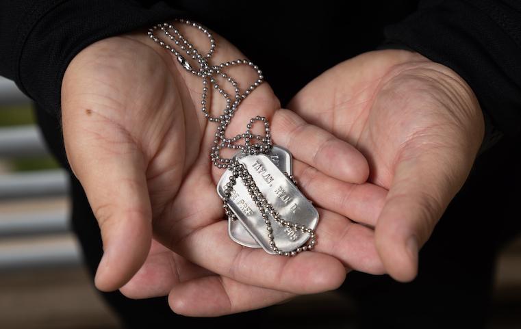 Ryan Taylan '22 holds a set of his U.S. Navy dog tags.