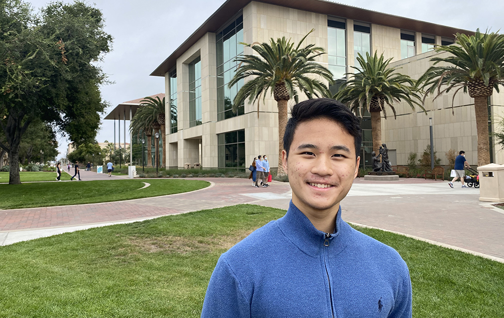 Jeffrey Ke stands in front of the library