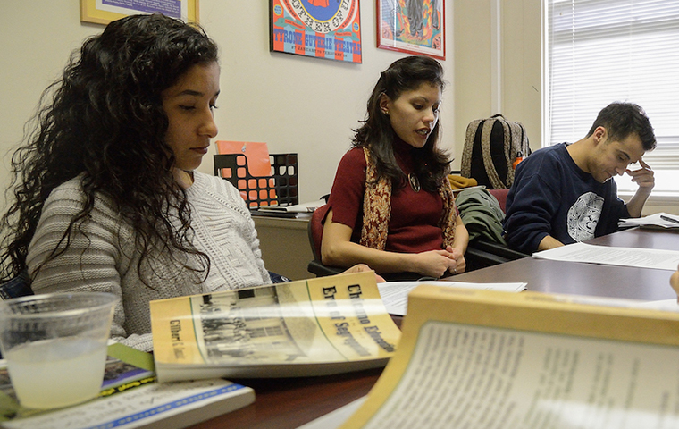 Jesica Fernandez working with students at a table