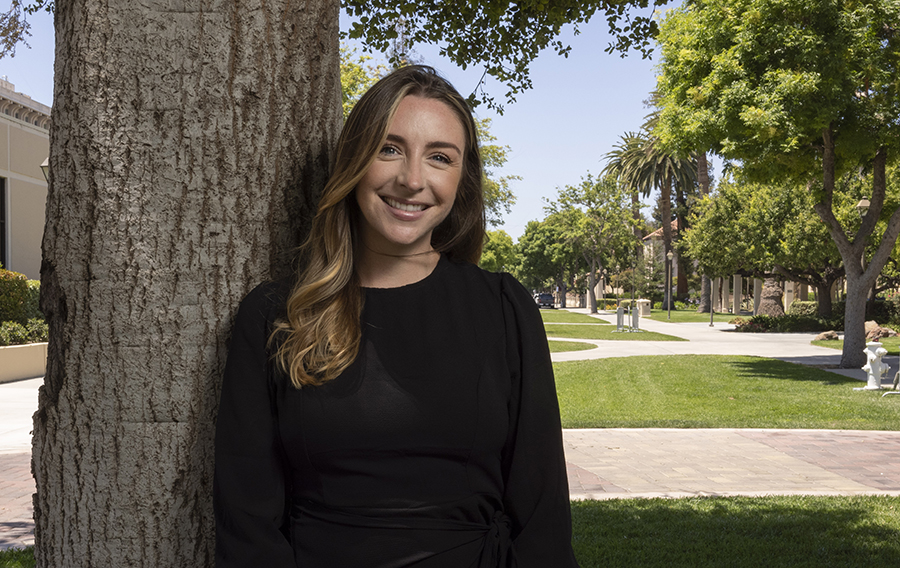 Mackenzie Vischer standing next to a tree outside of Benson