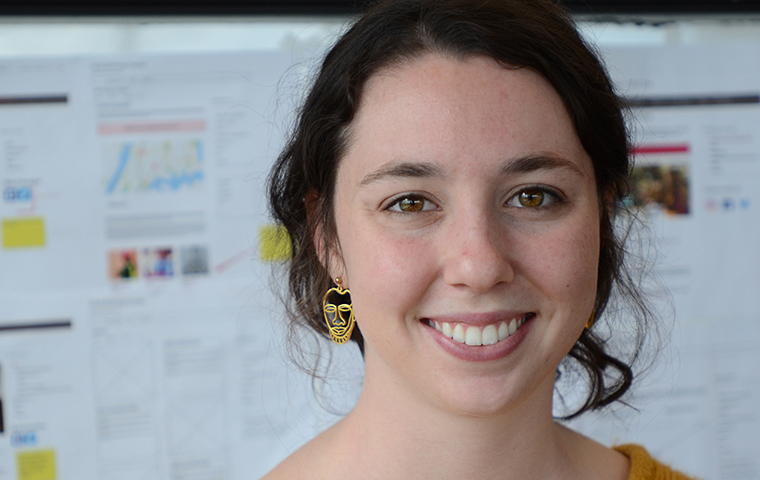 Mara Strong stands in front of web wireframes