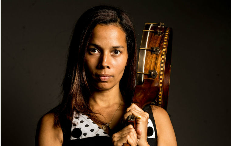 Rhiannon Giddens holding banjo over shoulder