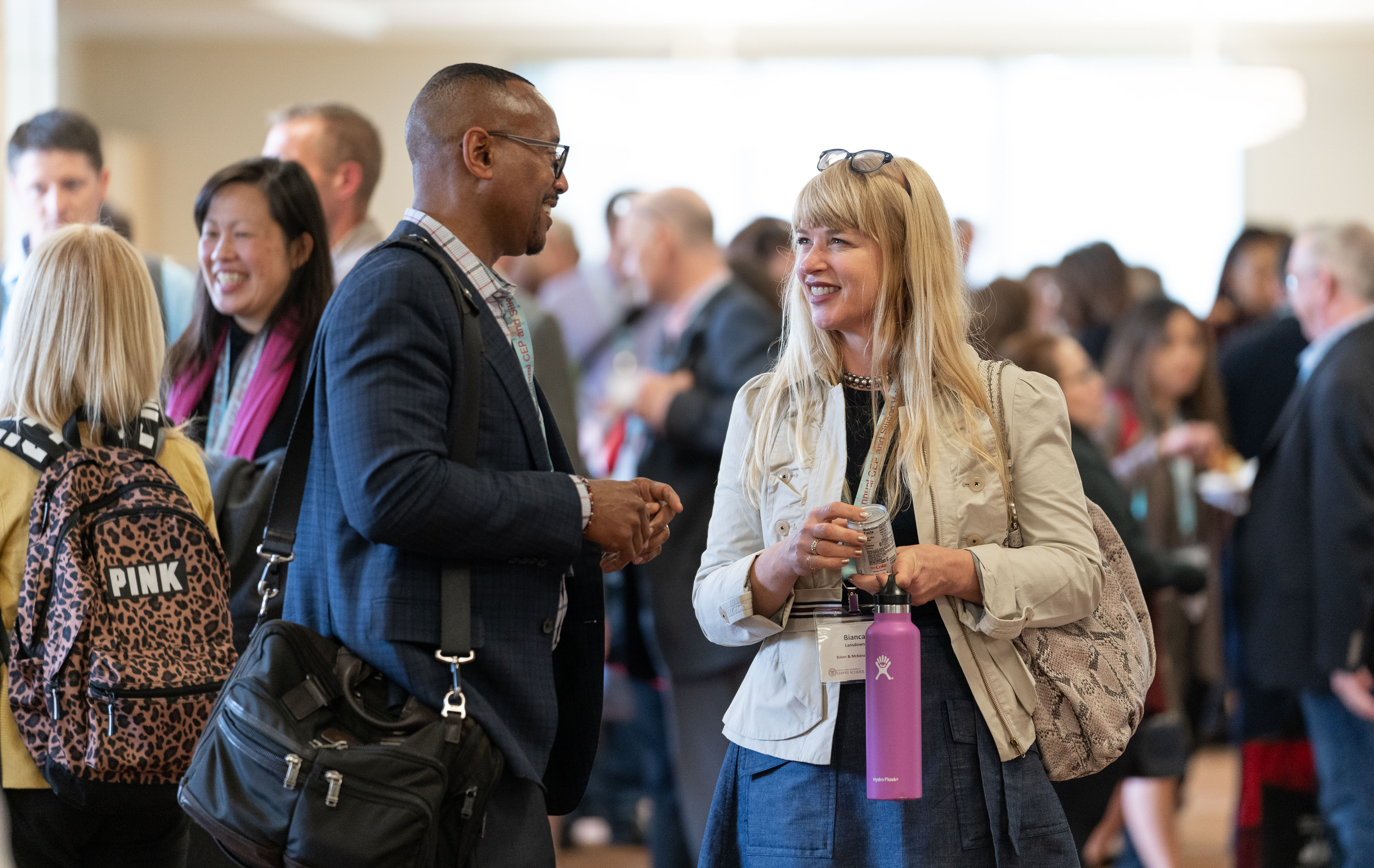 Unidentified attendees talking at an executive education conference at SCU