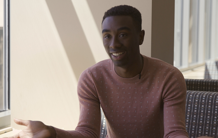 Austin Gray sits in front of a window